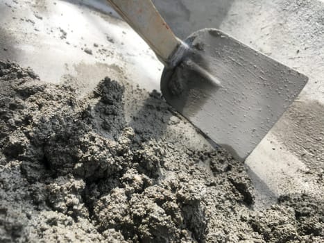 Close up Mixing of stone, cement, sand together to make a strong concrete floor, Construction concept
