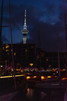 Auckland marina at night, the Skytower in the background, New Zealand