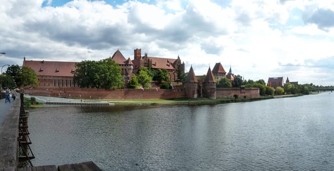 MALBORK, POLAND - SEPTEMBER 03, 2020 - Castle of the Teutonic Order in Malbork, panoramic view from the Nogat river, Poland