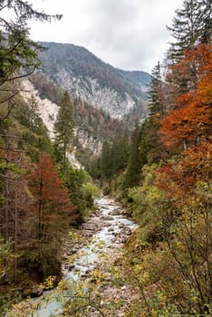 Hiking through the Vrata valley in autumn, Triglav National Park in the Julian Alps, Slovenia