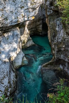 The Soca river flowing through a wild mountain landscape of the Julian Alps, Slovenia