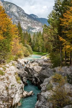 The Soca river flowing through a wild mountain landscape of the Julian Alps, Slovenia