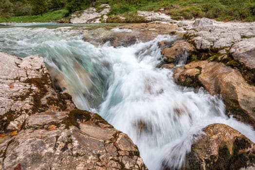 The Soca river flowing through a wild mountain landscape of the Julian Alps, Slovenia