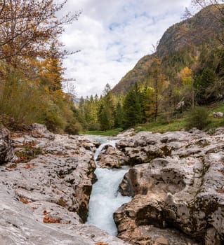 The Soca river flowing through a wild mountain landscape of the Julian Alps, Slovenia