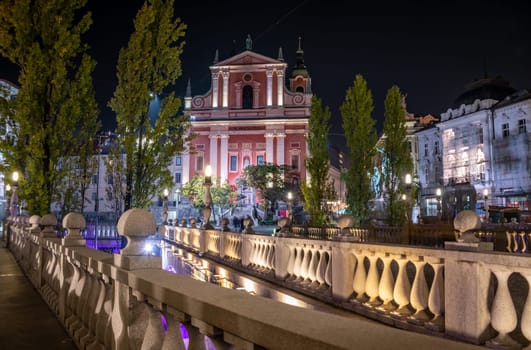 Famous Three Bridges and the Preseren square in the center of Ljubljana illuminated at night, Slovenia