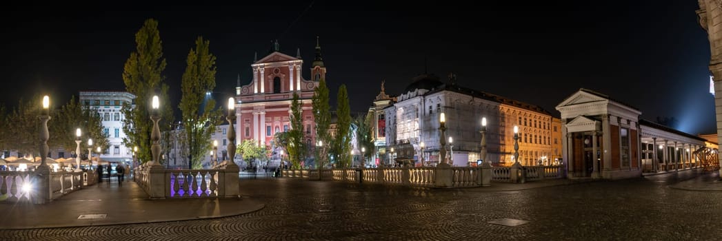 Famous Three Bridges and the Preseren square in the center of Ljubljana illuminated at night, Slovenia
