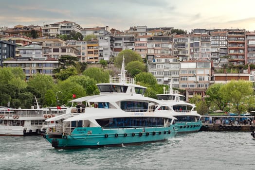 Istanbul, Turkey - May 10, 2023: Dentur Avrasya Grup modern passenger ferry boat leaving the Uskudar terminal in Istanbul heading to the European side of Bosphorus strait
