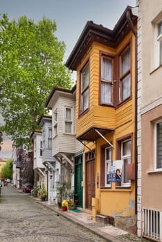 Istanbul, Turkey - May 9, 2023: Narrow cobblestone alley with colorful wooden houses, suited in Kuzguncuk neighborhood, Uskudar district