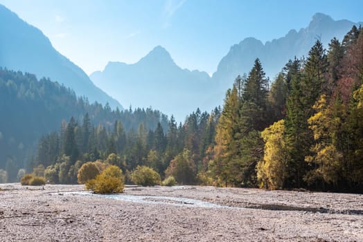 Scenic autumn forest at Crystal Lake in the Julian Alps, Slovenia