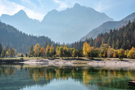 Scenic autumn forest at Crystal Lake in the Julian Alps, Slovenia