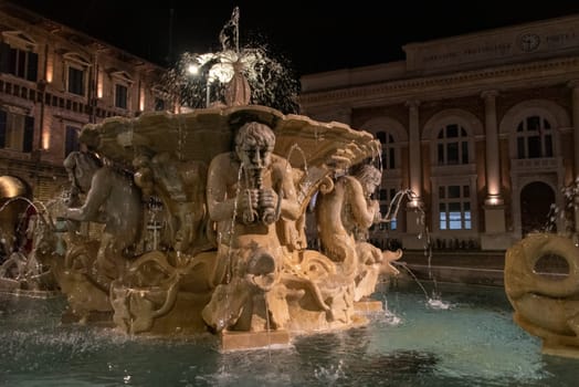 Baroque fountain in downtown Pescara, the city theater in the background, Southern Italy