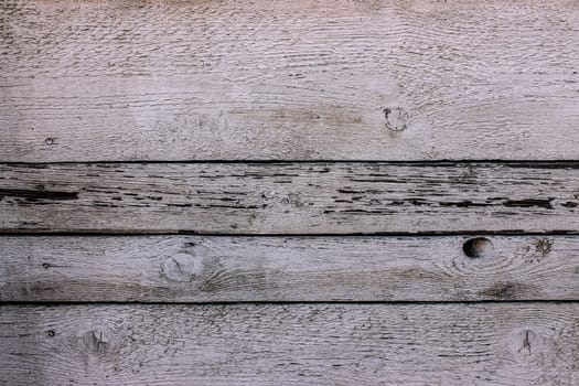 Old white stained-glass windows with traces and defects have gaps and nails.