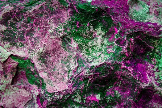 the texture of gray and white stones with green and raspberry color oxide