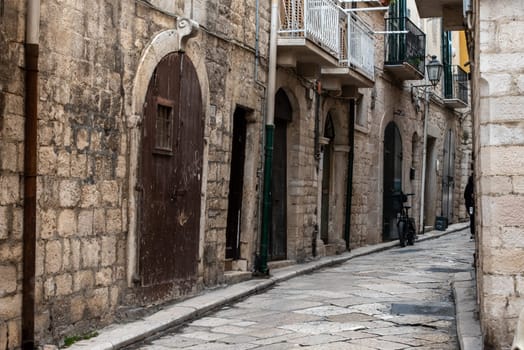 An abandoned narrow and stony alleyway in downtown Bari, Italy