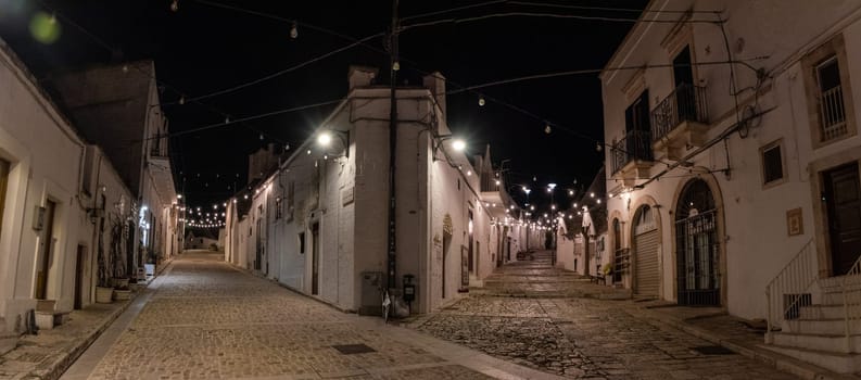 Scenic abandoned street in the Trulli district of Alberobello at night, Southern Italy