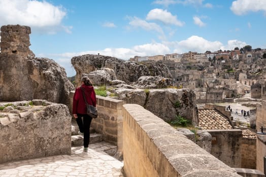 Female person hiking though the Sassi di Matera in Italy