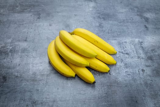 harvesting fresh bananas against a grey background