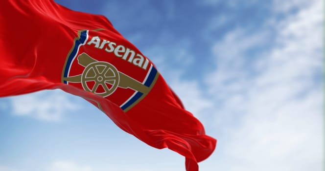 London, UK, May 2023: Arsenal Football Club flag waving on a clear day. English professional football club. illustrative editorial 3d illustration render. Rippled Fabric. Selective focus