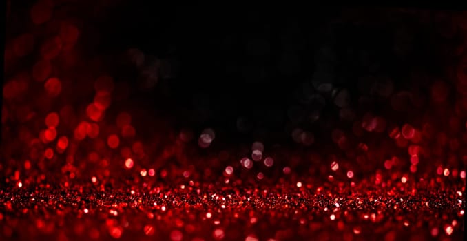 Abstract blur red glitter on black background. Card for Valentine's day, christmas and wedding celebration. Love bokeh sparkle confetti textured layout. Classy elegant design.
