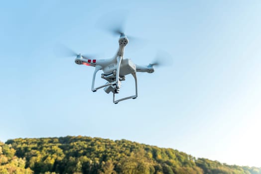 Drone with digital camera flying in the sky. Modern technology for aerial video and photography.