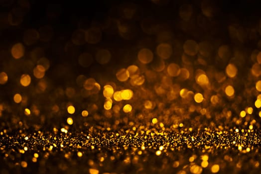 Blur gold light circle background. Sparkling firework bokeh dots on dark wall. Luxury and classy new year and christmas celebration party textured backdrop. Blurry golden dust frame design.