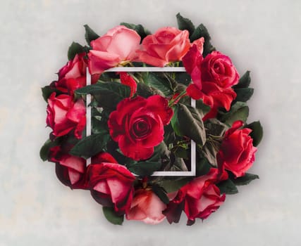 Beautiful red roses bouquet for valentie's day gift. Creative wedding flower decoration. Vintage valentine present with floral bloom and frame. Top view.