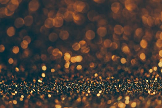 Blur neon gold light circle background. Sparkling firework bokeh dots in retro film filter style. Luxury and classy new year and christmas party textured backdrop. Blurry golden dust particles