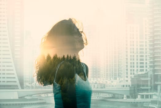 Double exposure with young woman in the modern cityscape and forest. Escape from the city concept.