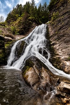 Water falls at the Bridal Veil waterfall in Cluj County Romania