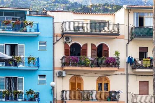 Giardini Naxos in Sicily Italy 08.11.2022 - Multicolored traditional houses with balconies in the port area