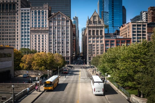 Traffic in downtown Chicago with people, trains, cars and buses