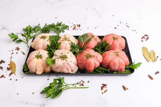 Pockets of raw beef and chicken with parsley on a platter