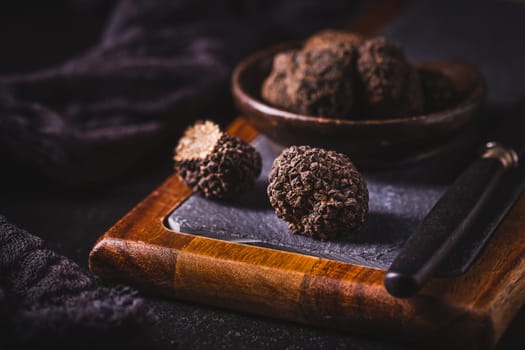 Expensive black truffles gourmet mushrooms  on kitchen table