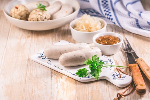 Bavarian white sausages with sauerkraut and bread dumplings, with mustard.