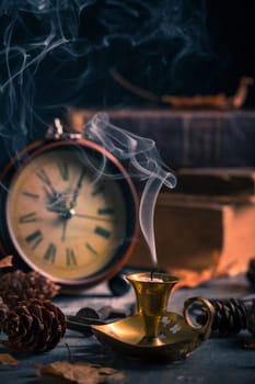 Vintage still life with  antique  books, clock and candle. Halloween and occult concept.