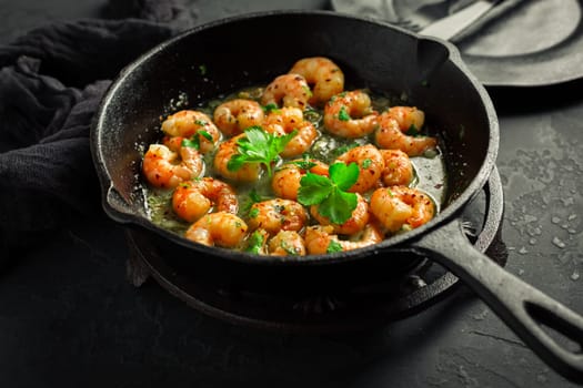 Roast Prawns Shrimps in a pan with herbs and garlic