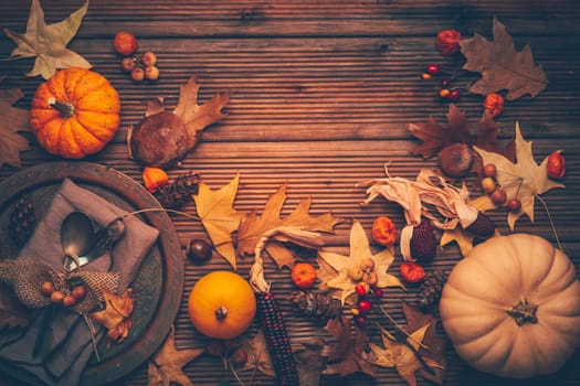 Autumn and Thanksgiving background with pumpkins and autumn leaves, place setting.