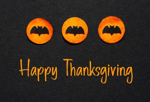 Black Halloween Background With Three Orange Dots With Bats And Text Happy Thanksgiving