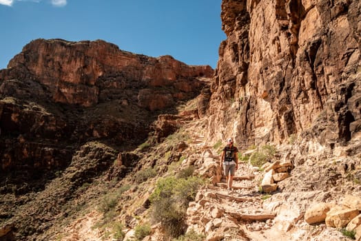 A female person hiking alone the Bright Angel Trail in the Grand Canyon, USA
