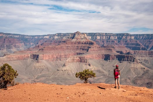 A female hiker enjoying the view from the famous Grand Canyon from South Kaibab trail, USA