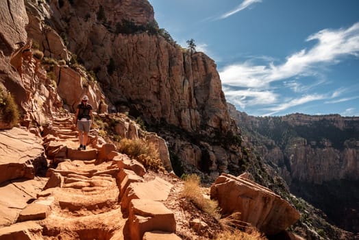 A female person hiking alone the Bright Angel Trail in the Grand Canyon, USA