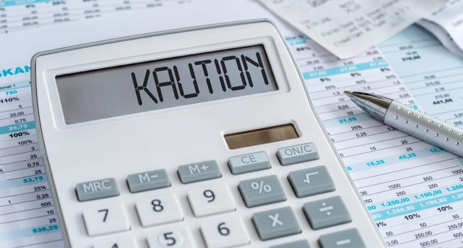 A calculator with the word Deposit in german on the display - Kaution