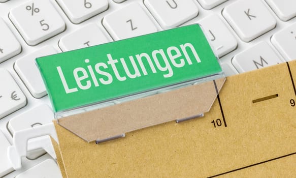 A brown file folder labeled Services in german - Leistungen