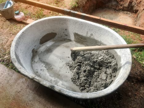 Mixing of stone, cement, sand together to make a strong concrete floor, Construction concept