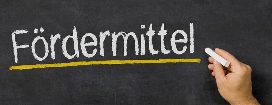 Text written on a blackboard - Funding in german - Fördermittel