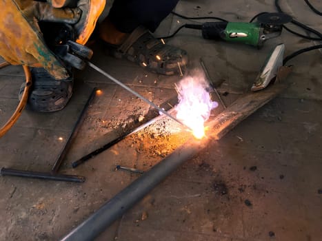 Man welding steel, blurred on black background, Welder concept, filter color style