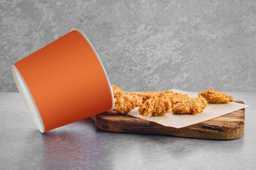 Deep fried chicken wings basket in breading scattered on parchment paper