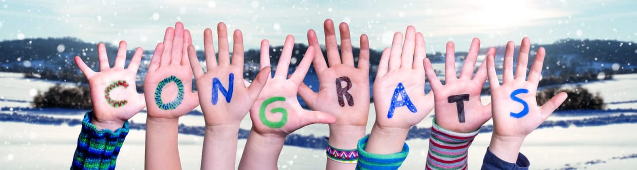 Children Hands Building Colorful English Word Congrats. White Winter Background With Snowflakes And Snowy Landscape.