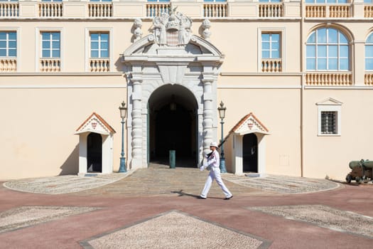 Monte Carlo - August 2022: guard with Summer uniform walking in front of the Royal Palace