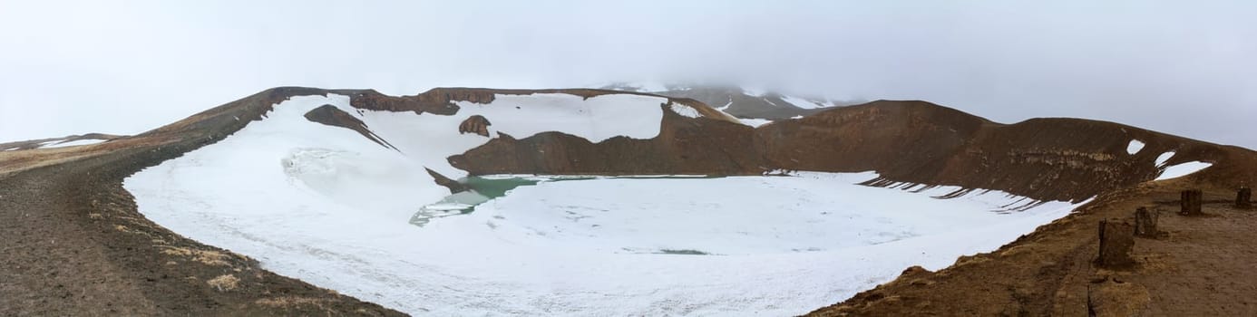 Panorama of a crater in Krafla covered in snow and ice, Iceland